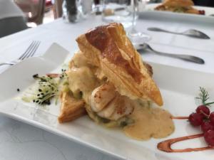 a white plate with a piece of food on a table at Logis - Hostellerie Le Chatel Nangis in Nangis +42 photos