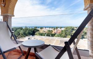 a balcony with chairs and a table and a view of the ocean at Meliá Zahara Resort & Villas in Zahara de los Atunes