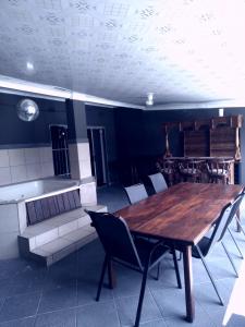 a dining room with a wooden table and chairs at Jnc Lodge in Richards Bay