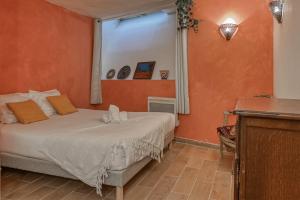 a bedroom with a bed with an orange wall at NOCNOC - Le Renversant in Marseille