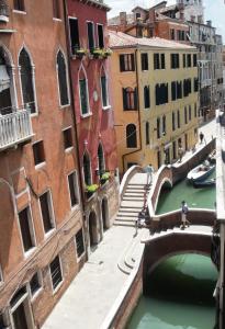 a view of a canal in a city with buildings at Palazzetto San Lio, Rialto in Venice