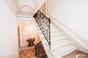 a spiral staircase with a vase of flowers on the floor at Palazzetto San Lio, Rialto in Venice