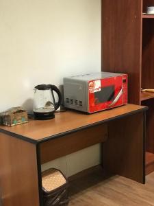 a toaster oven sitting on top of a table at Мини Отель «Positive” in Kyiv