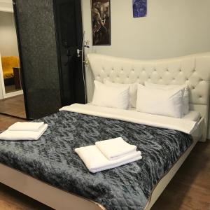 a bedroom with a bed with two towels on it at Мини Отель «Positive” in Kyiv