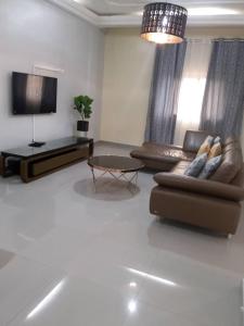 a living room with a couch and a coffee table at Your home II in Yaoundé