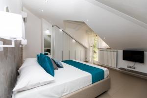 a bedroom with a large bed and a tv at Diamond apartment Agerola in Agerola