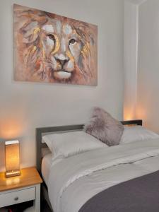 a bedroom with a painting of a lion on the wall at Holgate hideout in York