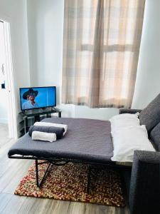 a bed sitting in a living room with a tv at Holgate hideout in York