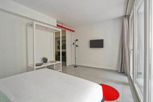 a white room with a bed and a television at Vatican Loft in Rome