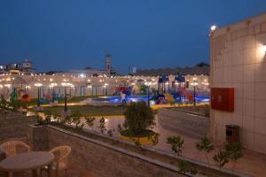 a view of a playground at night with lights at منتجع فيوري - الهدا in Taif