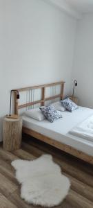 two beds in a room with two white rugs at Śpij w Kudowie pokoje gościnne in Kudowa-Zdrój