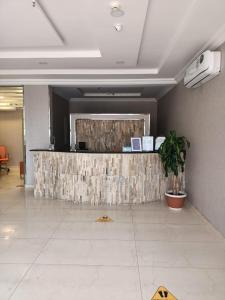 a lobby with a reception counter in a building at Fiori Resort in Taif