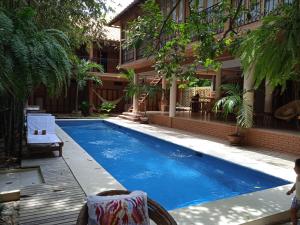 a swimming pool in front of a house at Hotel Bendita Luna in Mazunte