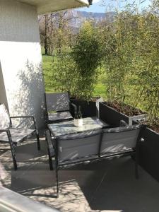 a patio with a table and two chairs on a porch at O2M Gresy sur aix in Mognard