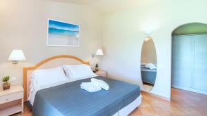 a bedroom with a bed with towels on it at Hotel Nibaru in Porto Cervo