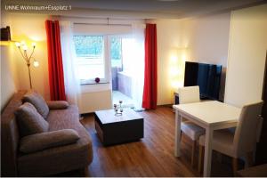 uma sala de estar com um sofá e uma mesa em Birkenblick Ferienwohnung Unne em Rimbach
