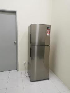 a stainless steel refrigerator sitting in a room at Padang Besar Homestay in Padang Besar