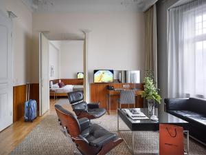 a living room with a couch and a table at K+K Hotel Central in Prague