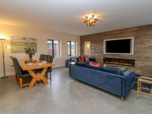 a living room with a blue couch and a table at Stackyard in Durham