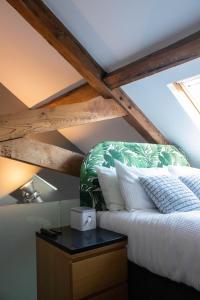 a bed in a room with a wooden ceiling at Tiger Roof Terrace Lymm in Lymm
