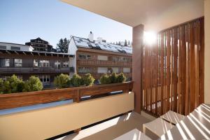 a balcony with a view of a city at Hotel Olympic - Montana Center in Crans-Montana