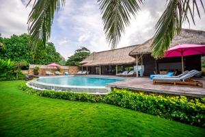 a villa with a swimming pool and a resort at Villa Jac in Selong Belanak