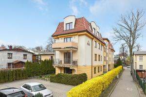 a house with a car parked in front of it at Blue Mandarin Apartments in Sopot