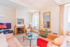 a living room with a couch and a tv at ON VILLEFRANCHE BAY - AP3040 by Riviera Holiday Homes in Villefranche-sur-Mer