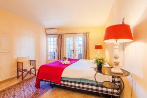 um quarto com uma cama com um cobertor vermelho em ON VILLEFRANCHE BAY - AP3040 by Riviera Holiday Homes em Villefranche-sur-Mer