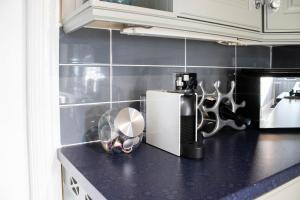 a kitchen with a counter top with a blender at Trafford Terrace Davyhulme in Urmston