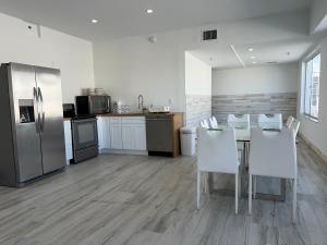 a kitchen with a table and chairs and a refrigerator at SOBE suites in Miami Beach in Miami Beach