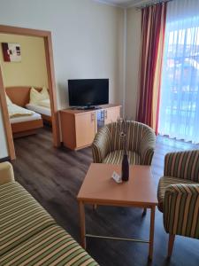 a hotel room with two chairs and a tv at Hotel Stocker in Krieglach