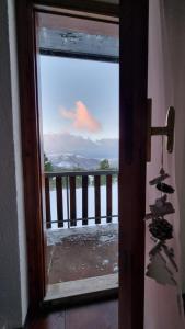 a view of a balcony from a door with a window at Appartamento immerso nella natura in Frontignano