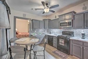 a kitchen with a table and a ceiling fan at Uptown NOLA Abode, 4 Miles to the French Quarter! in New Orleans