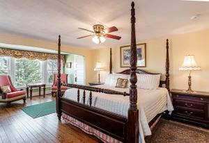 a bedroom with a large bed and a ceiling fan at Echo Mountain Inn in Hendersonville