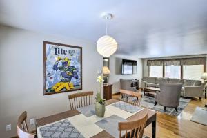 a dining room and living room with a dining table at Green Bay Home 3 Blocks to Lambeau Field! in Green Bay