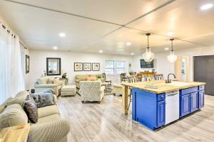 a kitchen and living room with a couch and a table at Bright Beaufort Home with Porch and Fire Pit! in Beaufort
