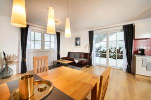 a living room with a table and a dining room at Mountainfloor in Grossarl
