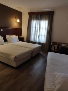 En eller flere senge i et værelse på Hotel O Gato - Edificio Standard