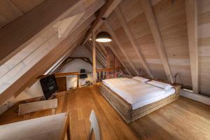 an attic bedroom with a bed and a television at Herzkammer (chamber of the heart) in Kandern