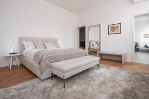 a white bedroom with a white bed and a white couch at Design Apartment with Balcony on the Grand Canal R&R in Venice