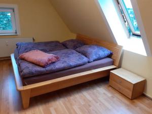 a bed with two pillows on it in a room at Schöne und ruhige Ferienwohnung in Ottendorf in Sebnitz