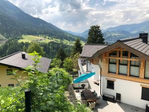 a view of a house with mountains in the background at Penthouse Alpendorf in Sankt Johann im Pongau