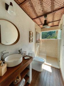 a bathroom with a sink and a toilet and a mirror at Reserva Natural Tierra Adentro in Minca