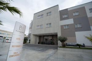 a building with a sign in front of it at Building Hotel in Teverola