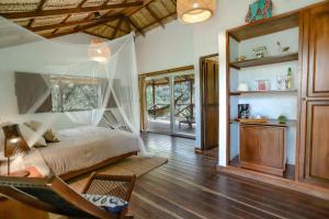a bedroom with a bed and a hammock in a room at Reserva Natural Tierra Adentro in Minca