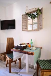 a room with a table and a chair and a window at Le Comprese - B&b Experience in Battipaglia