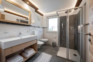 a bathroom with a sink and a shower at Obergasserhof in Rodengo +21 photos