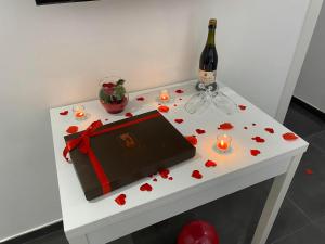 a table with a bottle of wine and hearts on it at Dimora al Centro in Cosenza +46 photos