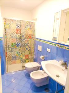 a bathroom with a toilet and a sink and a shower at Agora Apartments -Casetta Sorrentina in Sorrento